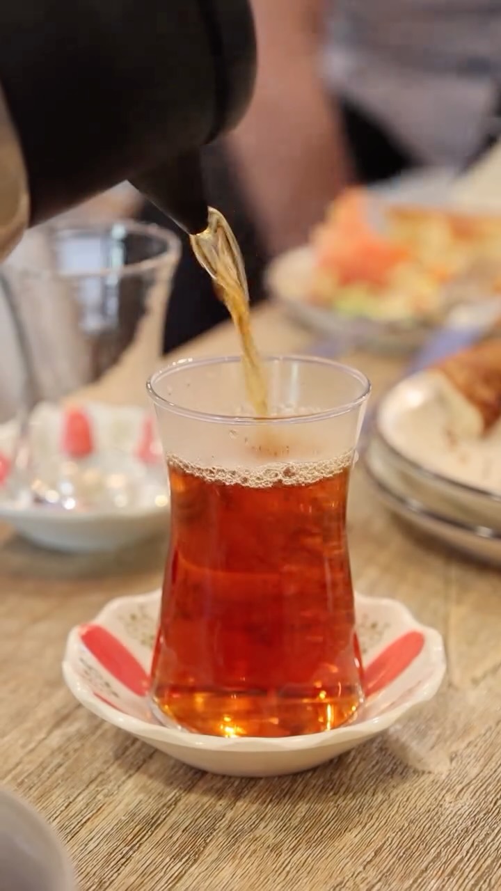 Turkish tea being poured into a tulip glass