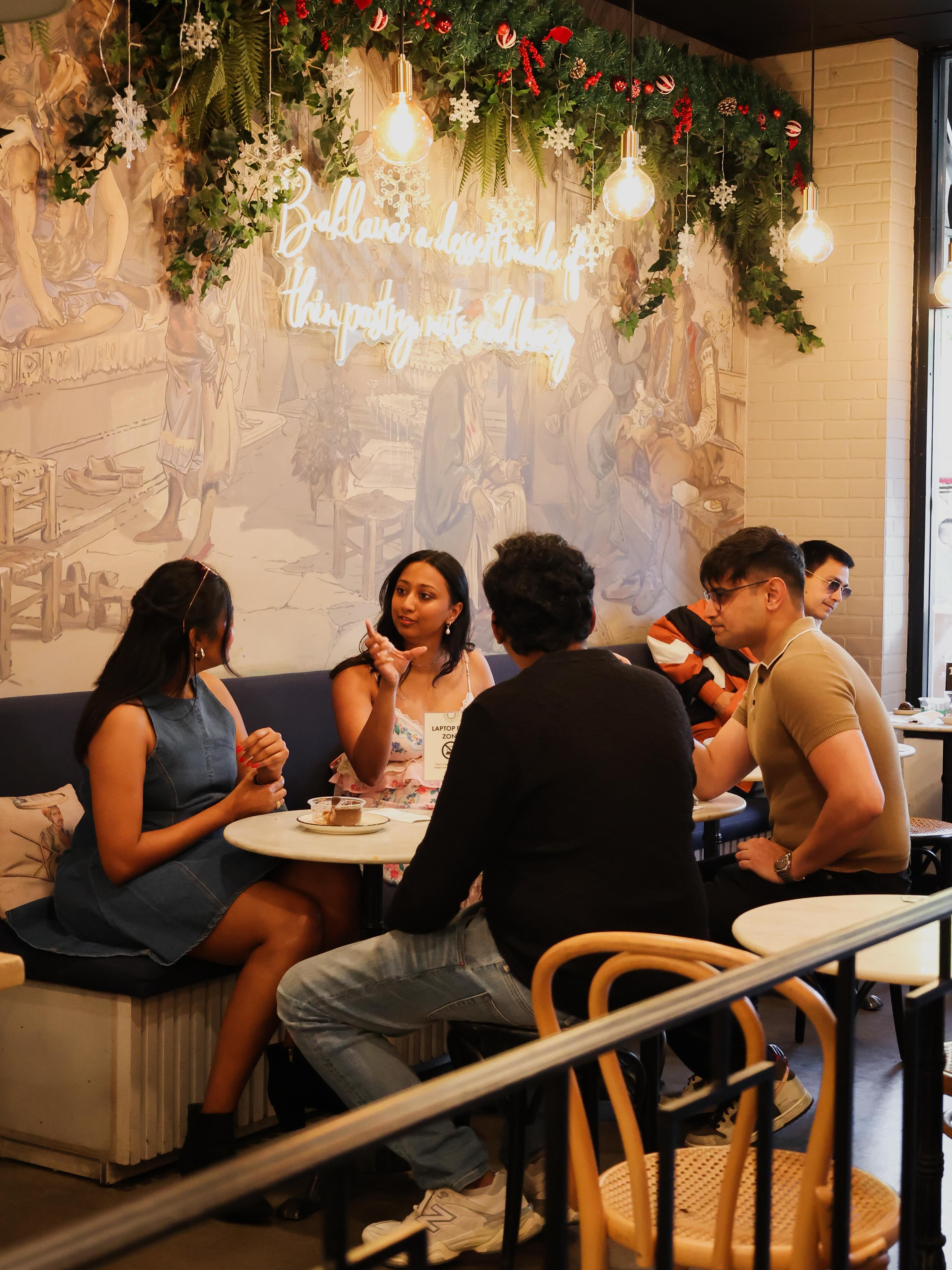 Cozy interior seating under a neon baklava sign